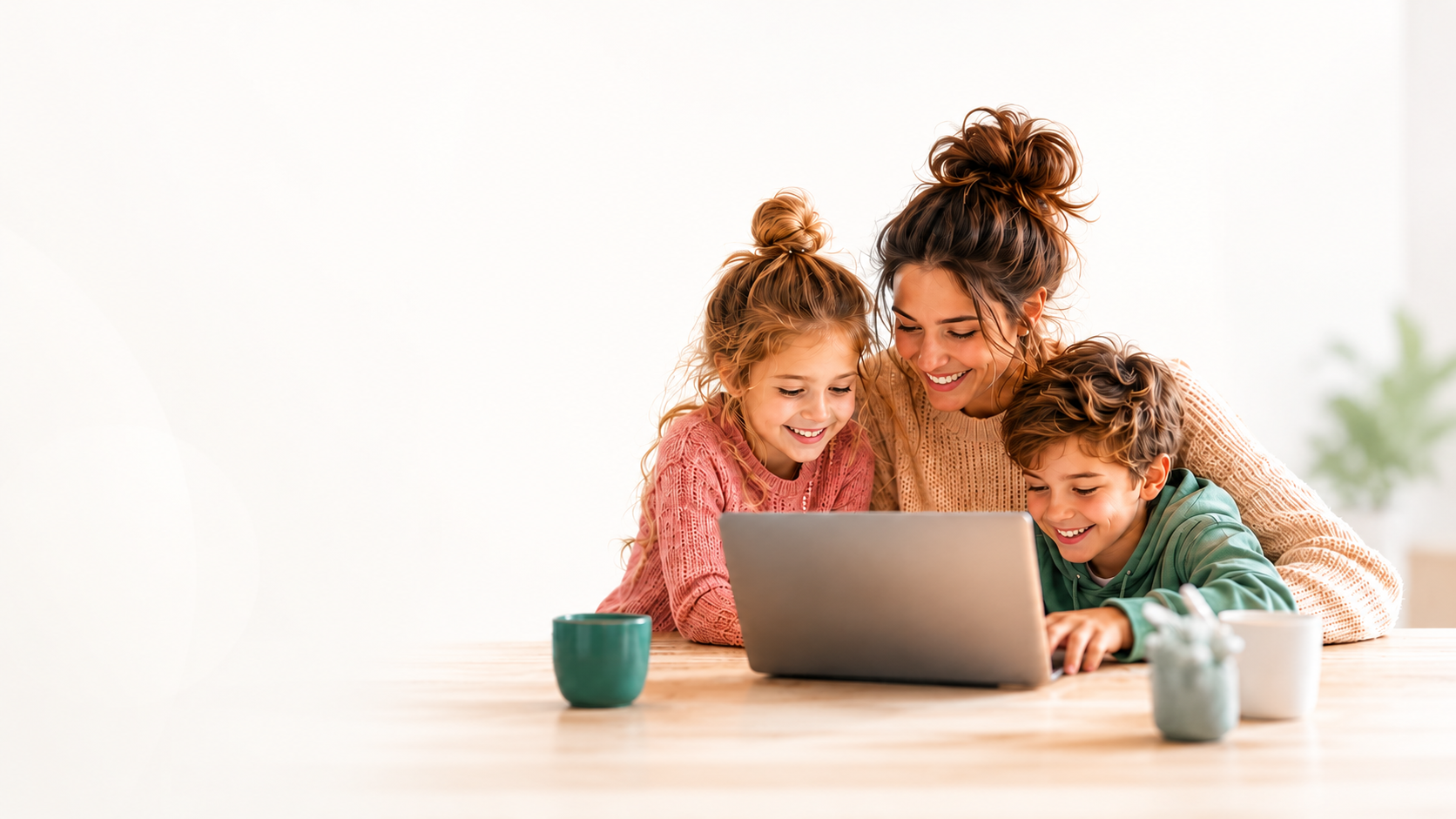 Mother with two children smiling while using a laptop at home